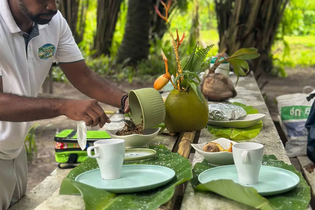 Guide serving breakfast in the forest of palm trees on the Essequibo Coast in Guyana. Photo by Becca Marsh