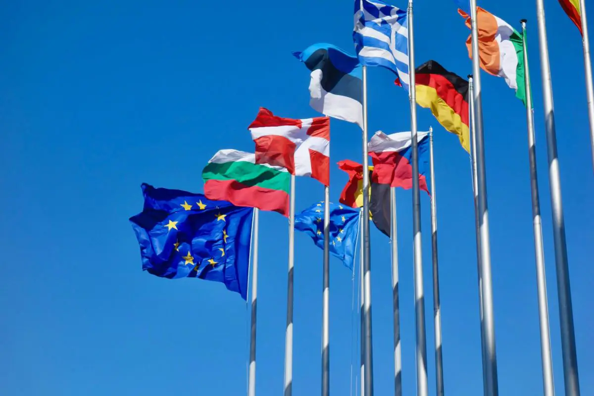 European Union flags flying on a clear day at the Parlement Européen, Strasbourg, France. Photo by Antoine Schibler from Unsplash