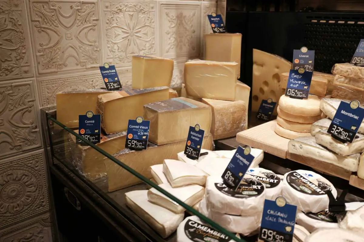 Cheese stand at a market in France showing 'reblochon' - a cheese from the alps region used to make tartiflette. Photo by T from Unsplash