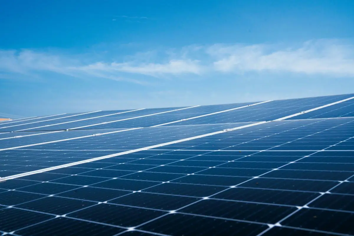 Where solar panels meet the sky, a view of solar panels basking in the sun. Photo by Soren H from Unsplash