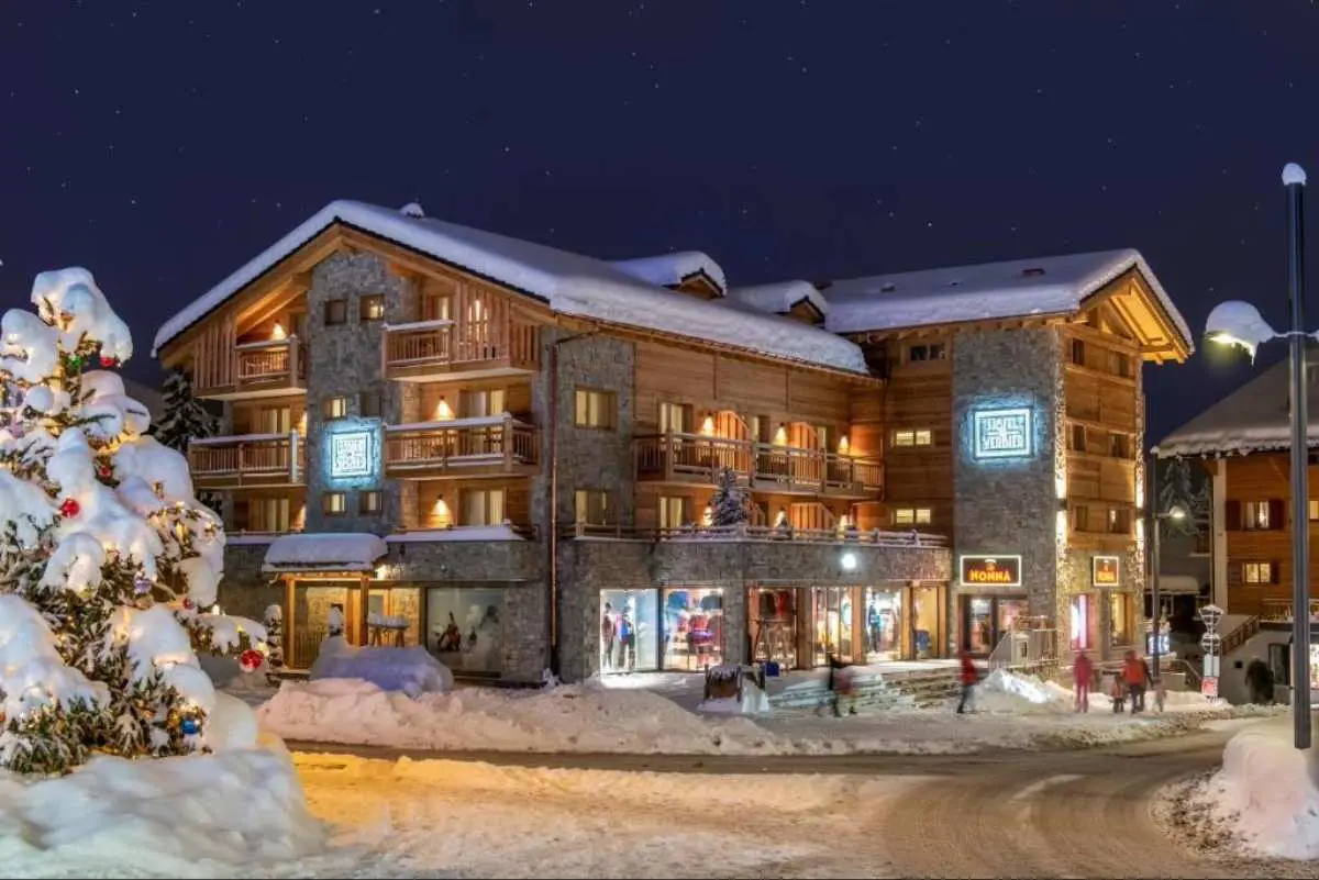 Central Hotel With A Snow Capped Roof At Twilight. Verbier, Swizterland.