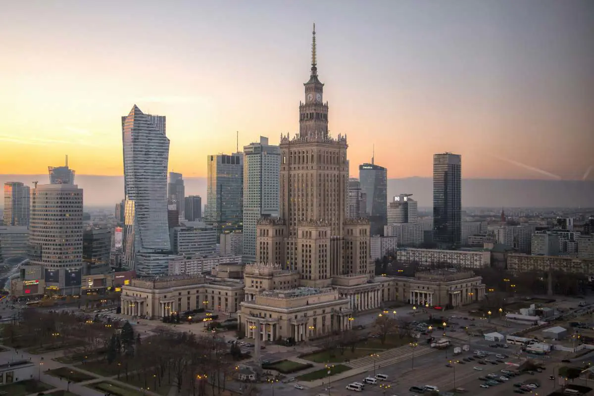 Palace of culture and Science buildings at sunset in Warsaw, Poland. Photo by Iwona Castiello D Antonio from Unsplash