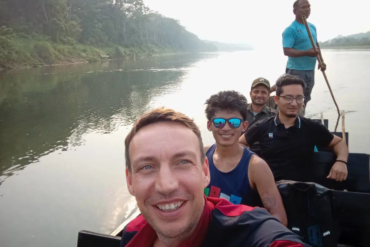 Paddy Cooke, guide et compagnons d'exploration sur un bateau traversant le parc national de Chitwan, au Népal. Photo de Paddy Cooke.
