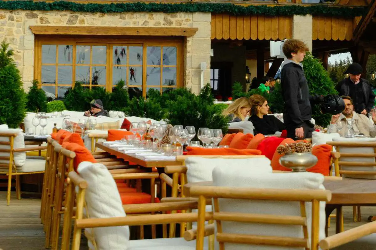 Tables set up ready for guests at a mountain top restaurant at Courchevel ski resort, France. Photo by Dick Hoogerdijk from Unsplash