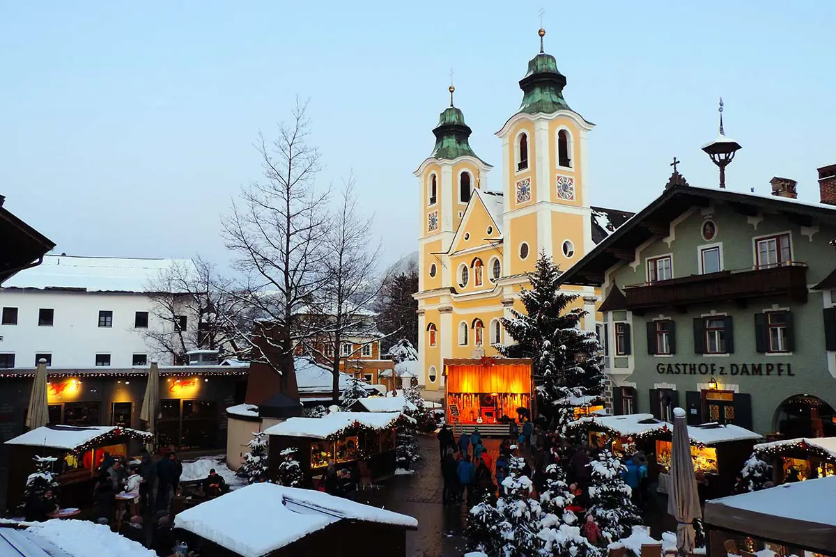 Christmas Market With Church and Lights in St. Johann in Tirol, Austria. Photo by Alfred Stier, Pixabay.