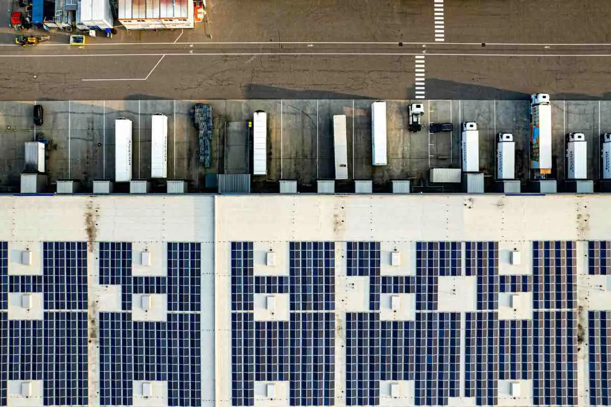 Aerial View Of Solar Panels Being Used On The Roof Of A Warehouse. Photo By Bernd Dittrich From Unsplash