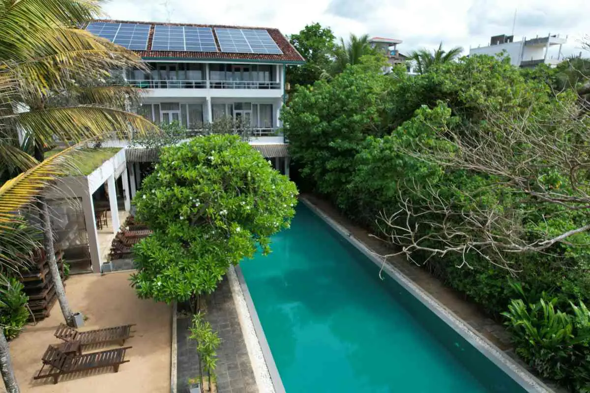 Aerial view of Roman Beach Hotel's pool and solar panels located in Sri Lanka. Photo by Antonio Araujo from Unsplash