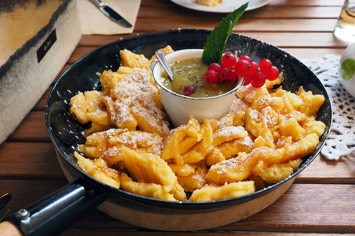 Kaiserschmarrn Austrian Dessert With Powdered Sugar and Fruit Compote Served in Pan. Photo by Hans, Pixabay.